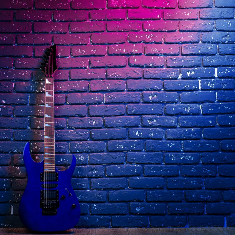 electric-guitar-in-neon-light-against-dark-walll.jpg